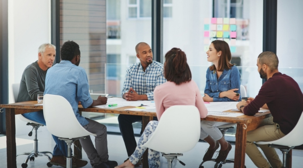 Group of employees at conference table.