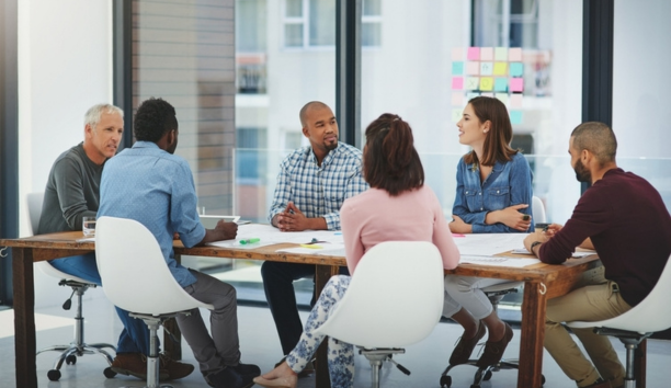 Group of employees at conference table.